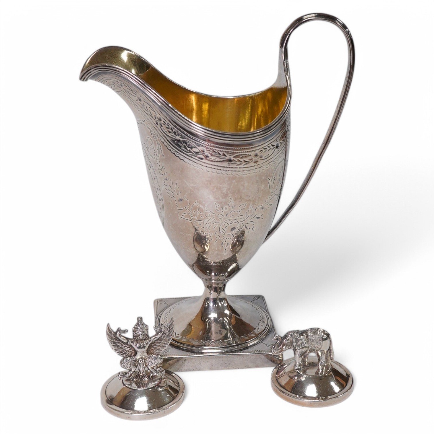 A George III silver helmet shaped cream jug by Peter & Ann Bateman, London, 1792, 14.4cm, together with two sterling menu holders. Condition - fair to good